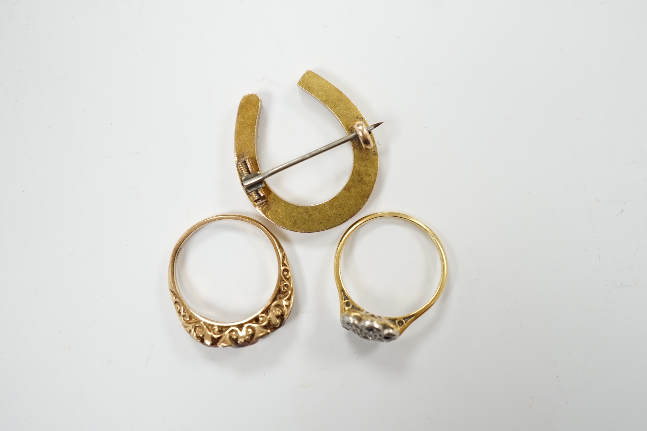 A 1920's 18ct, plat and millegrain set diamond flower head cluster ring, size L/M, a later 9ct gold and three stone citrine ring, with rose cut diamond chip spacers and a yellow metal seed pearl cluster set horseshoe bro